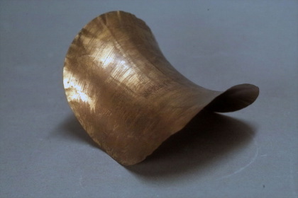 Brass plates of constant negative curvature
