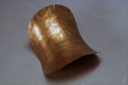 Brass plates of constant negative curvature